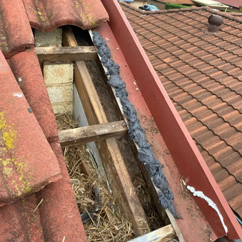Broken tiles and a deteriorated valley before repair