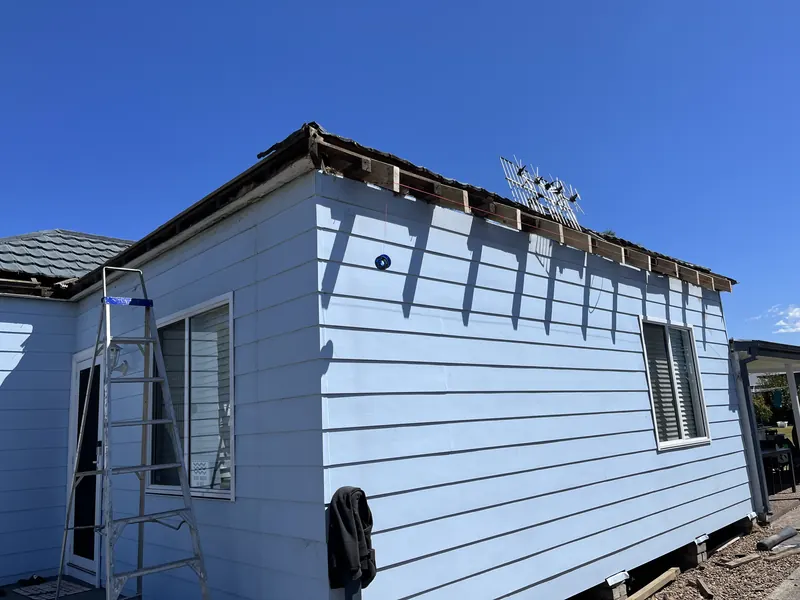 Weatherboard cottage before the old roof was replaced