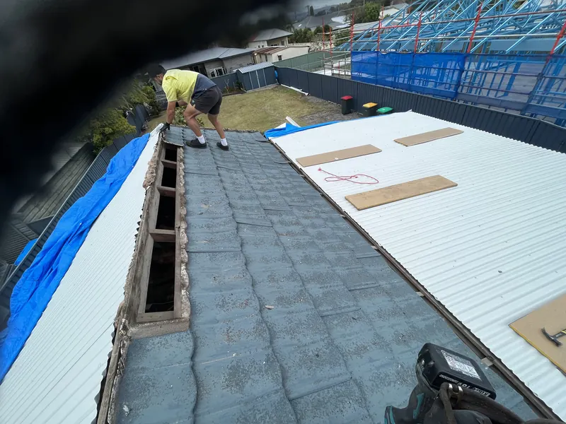 New roof sheets going on beside the old tiled section