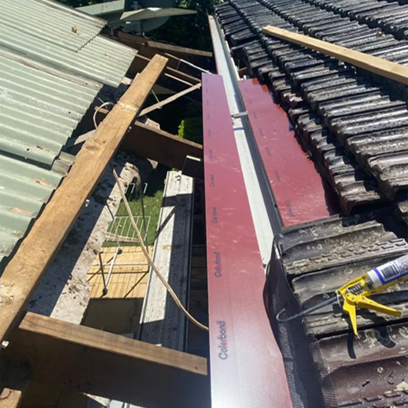 New valley iron being installed in a tile roof