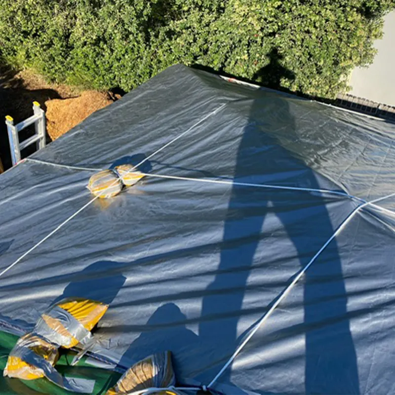 Tarp over a roof secured with sandbags