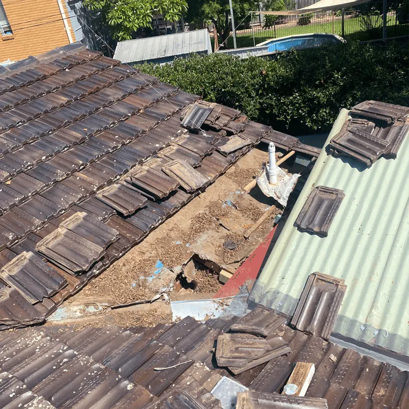 Damaged tile roof before replacement