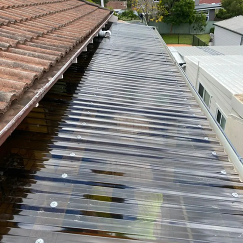 Clear roof sheeting beside a tile roof