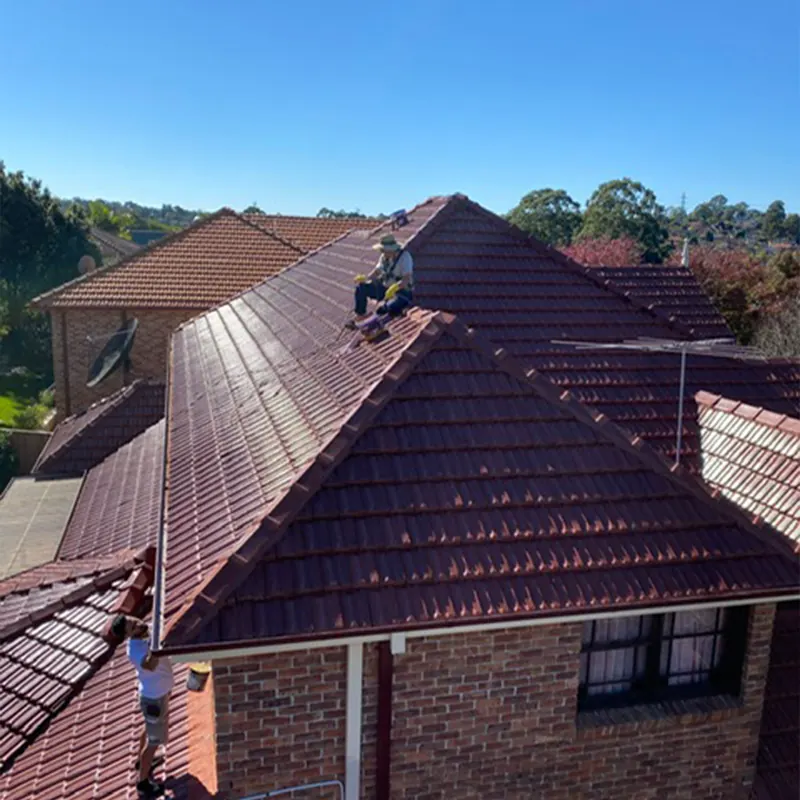 Roofer working on a red tile roof