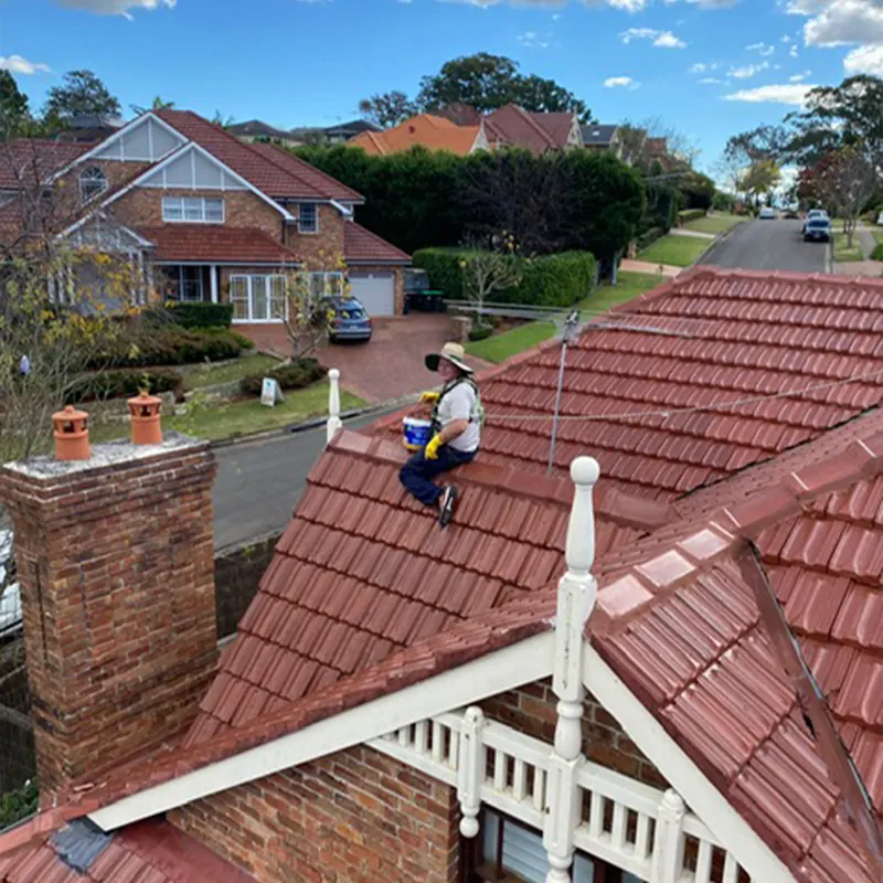Roofer on a terracotta tile roof