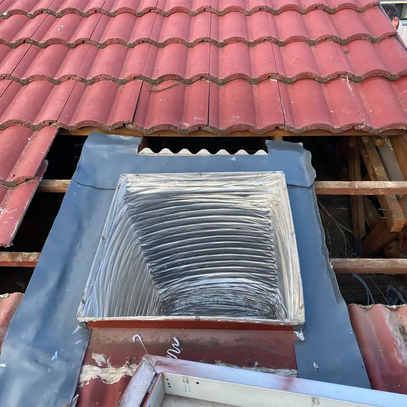 Skylight shaft and flashing in a tile roof
