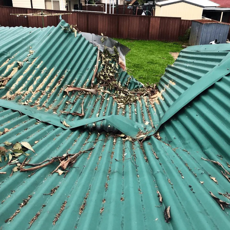 Storm-damaged corrugated roof before replacement
