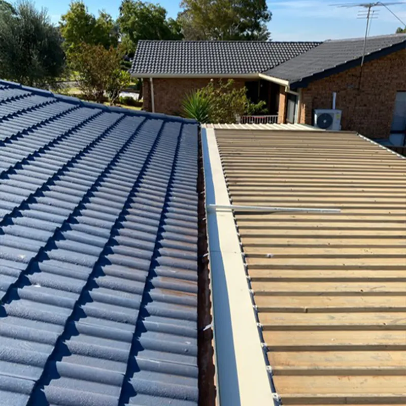 Metal sheeting going on alongside a tile roof