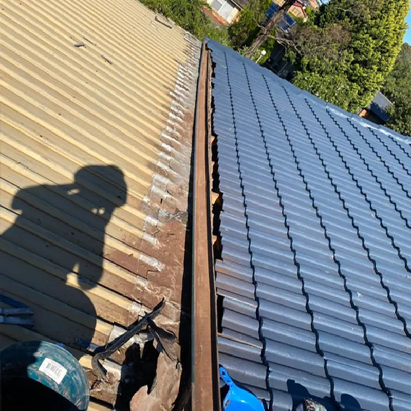 Join between new metal roofing and old tiles